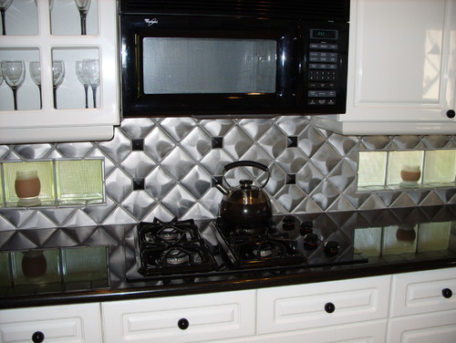 White Cabinet with Stainless Steel Backsplash and Uba Tuba Granite